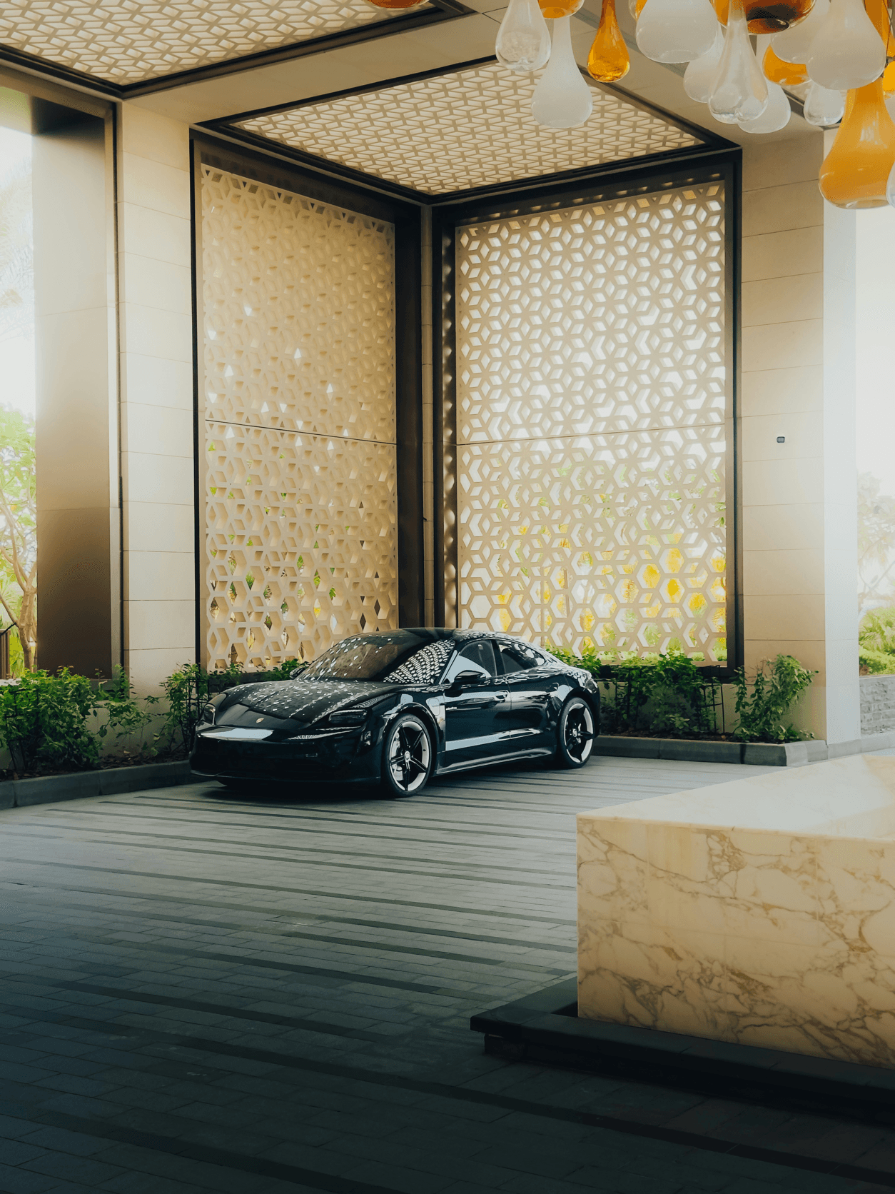 Black luxury car waiting at an elegant hotel portico before the ceremony