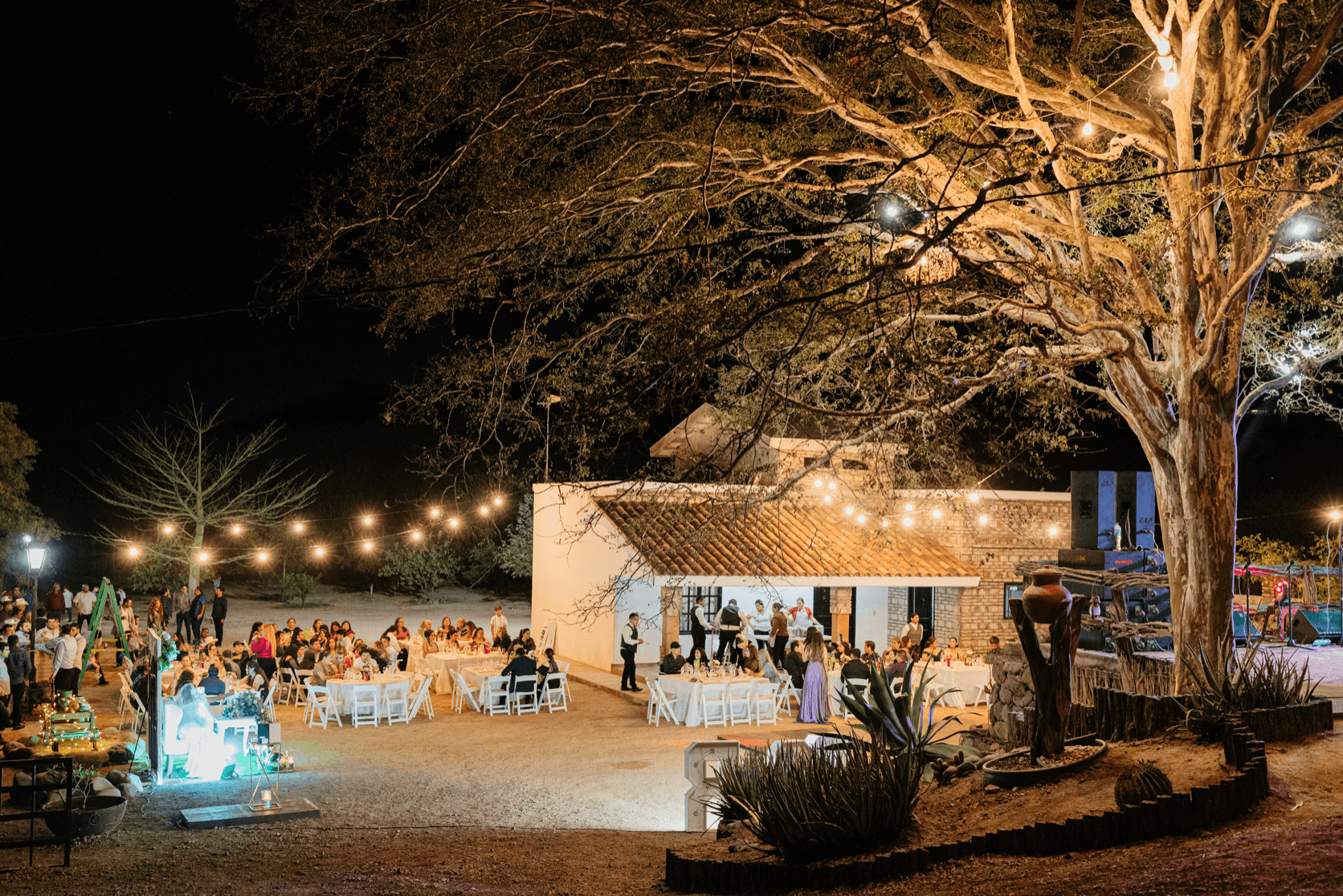 Evening wedding reception with warm string lights after the celebration
